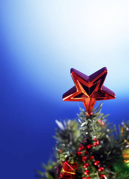 istock Close up Christmas tree and star tree topper 1635505499