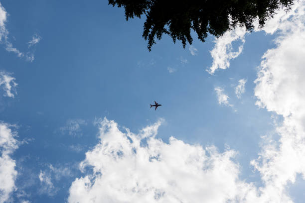airplane flying away in to sky high. travel concept
