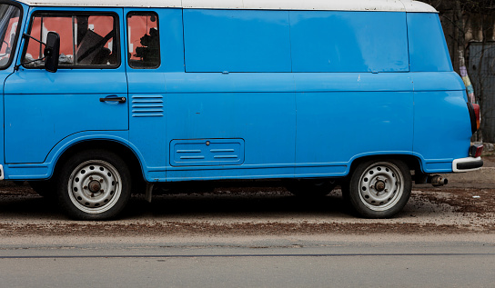 Old blue vintage van parked in city. retro transport