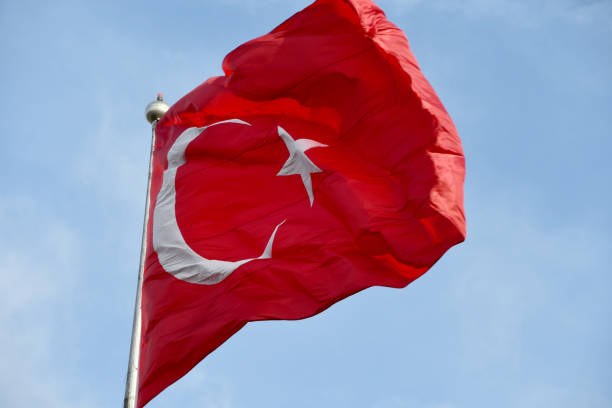 istock Turkish flag waving in the sky 1635522650