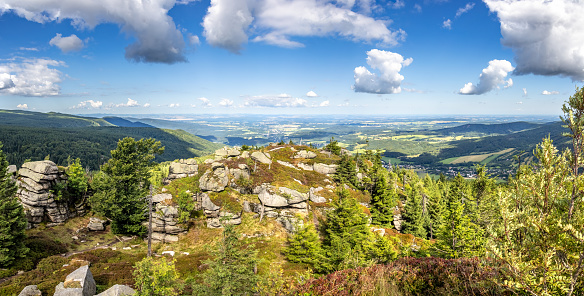Panoramic photo with view from mountains to valley under summer blue sky with white clouds - Jizera Mountains, Czech Republic, Europe