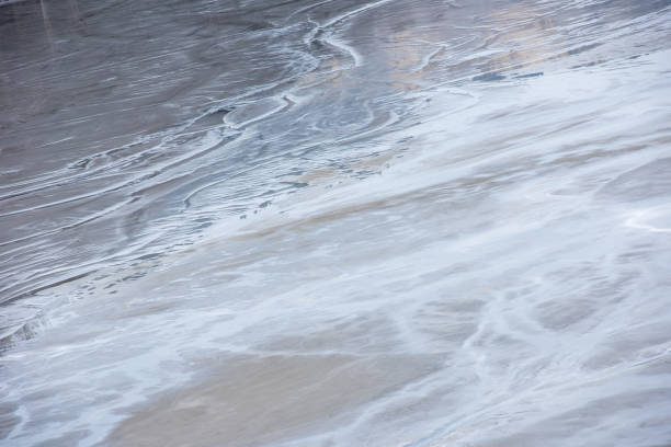 istock Muddy waters in a decanting pond. Toxic residuals from a copper mine decanting in a settling basin 1635527544