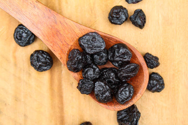 istock Dried Blueberry in a wooden spoon close-up view 1635569701