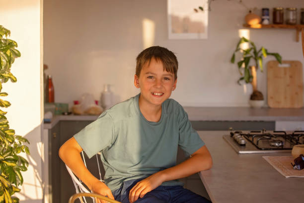 istock Cute blond child, boy, eating soup at home for dinner, summertime 1635570811