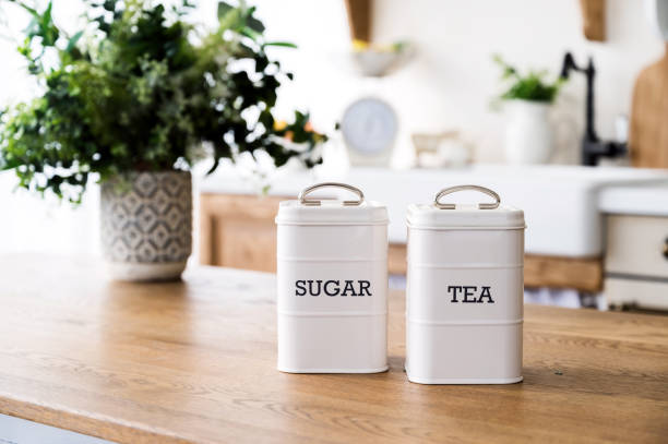 istock sugar and tea canisters set in retro style on wooden dining table 1635578842