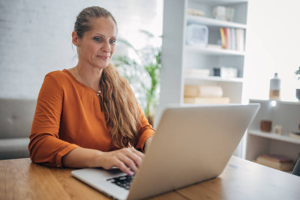 istock Woman freelancer working on laptop at home 1635590111