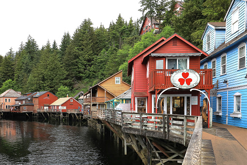Ketchikan, Alaska, USA - July 11, 2023:  Historic Creek Street, a hugely popular historic area. Mounted on stilts, the street is a boardwalk with shops, restaurants and eagles perched above.