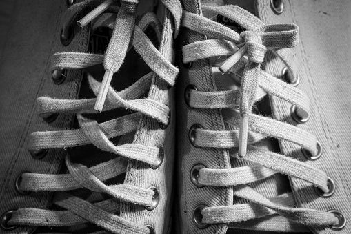 Tie the laces on the shoes.