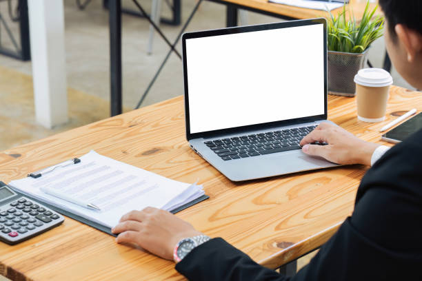 istock Businessman working on laptop with blank screen with copy space screen for your advertising text message in office 1635597689