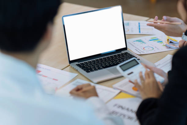 istock Team Businesspeople looking at blank screen on laptop with mock up copy space for your advertising 1635599487