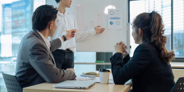istock Young Business answering a colleague question during a presentation in boarding room 1635600452