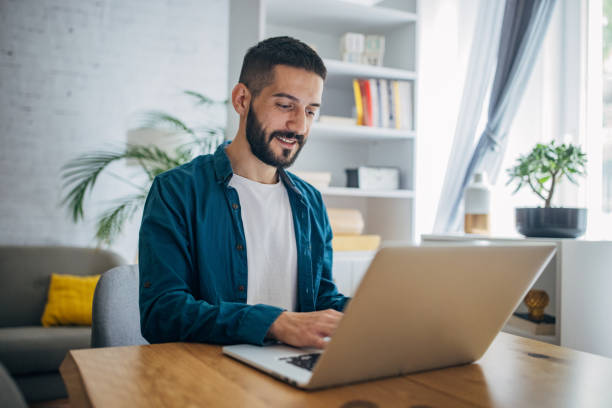 istock Man working on laptop at home 1635602039