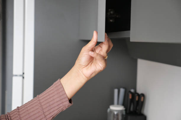 istock women hand open a kitchen cabinet drawer 1635610978