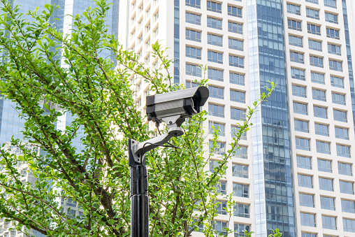 Security surveillance camera in front of office building. CCTV camera home security system