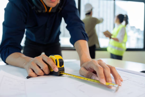 istock Construction and structure of Engineer or architect meeting for project working with partner and tools on model building and blueprint in working site 1635629460