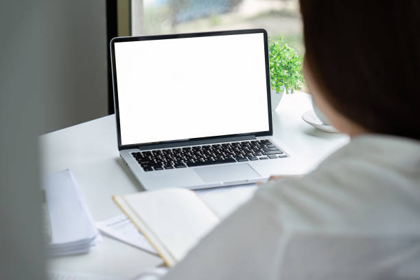 istock Businessman working on laptop with blank screen with copy space screen for your advertising text message in office 1635635917