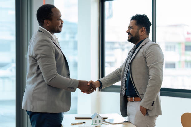 istock Real Estate agent and customer shaking hands after successful contract 1635637583