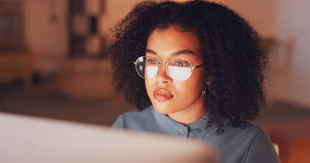 reflection, black woman and employee with glasses, night and online reading in workplace, deadline or schedule. african american female entrepreneur, consultant or journalist with eyewear and reflect - financial occupation research data glasses imagens e fotografias de stock