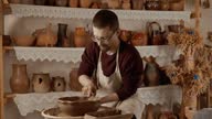 istock Working process in ceramic workshop. Crafting work concept. Man potter working 1635653779