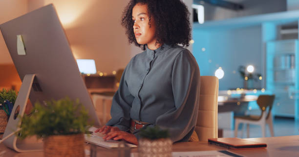 istock Night, thinking and computer with black woman in office for research proposal, project and satisfaction. Internet, technology and idea with employee in agency for information, confident or connection 1635656984