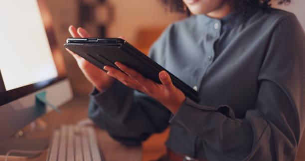 istock Technology, internet and information with employee browsing online for connection, website and deadline. Scrolling, tablet and hands of woman in office at night for research, overtime and analysis. 1635656985