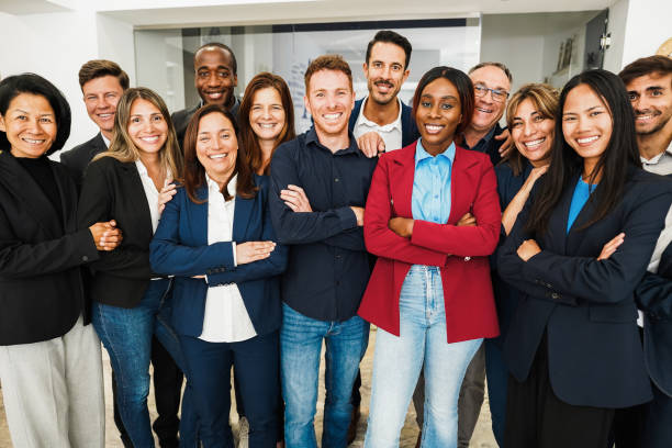 istock Multigenerational workers smiling in front of camera inside business office - Multiracial, job employees, entrepreneur and teamwork concept - Main focus on center faces 1635674808