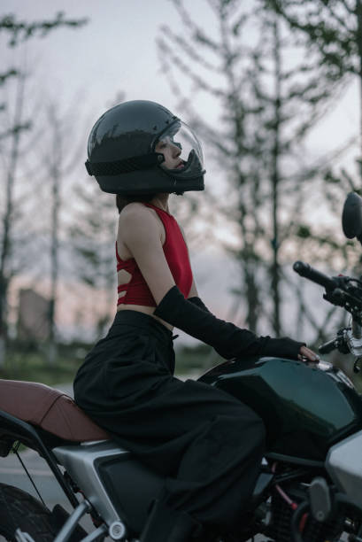 istock Asian woman in red on a motorcycle 1635676448