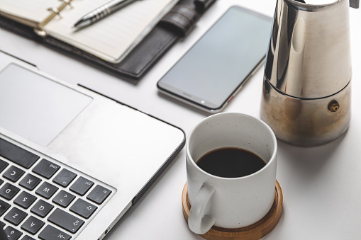 close up of smartphone, laptop, note, and coffee cup. business and workplace concept. isolated freelancer tools