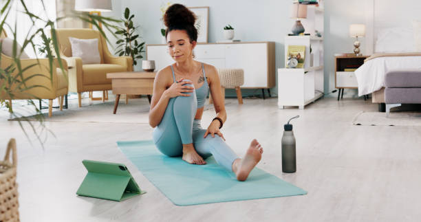 istock Exercise, yoga and tablet with fitness woman streaming online class, tutorial or live stream on internet virtual training in lounge at home. Fit female using technology for spiritual wellness workout 1635692763