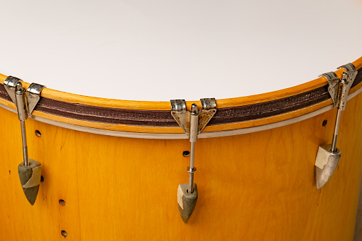 close-up of repairing or adjusting the tension of a musical bass drum