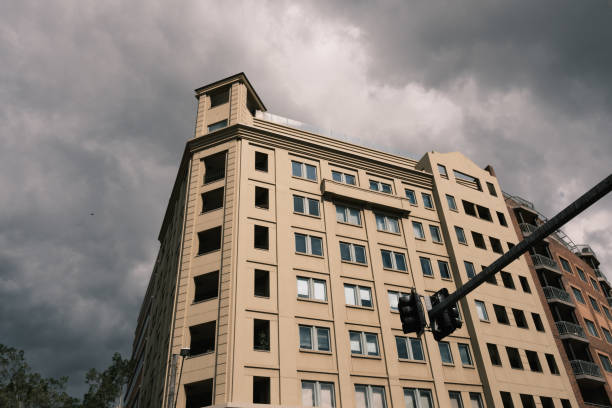 istock Old apartment building with dark stormy sky 1635694398
