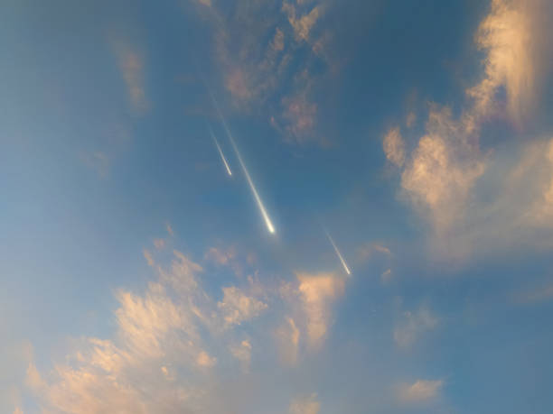 Falling meteorites in the blue sky. Shooting stars, daytime fireballs. Beautiful meteors in daylight.