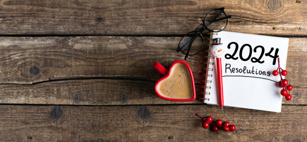 istock New year resolutions 2024 on desk. 2024 goals list with notebook, coffee cup on wooden table. Resolutions, plan, goals, action, checklist, idea concept. New Year 2024 resolutions 1635714214