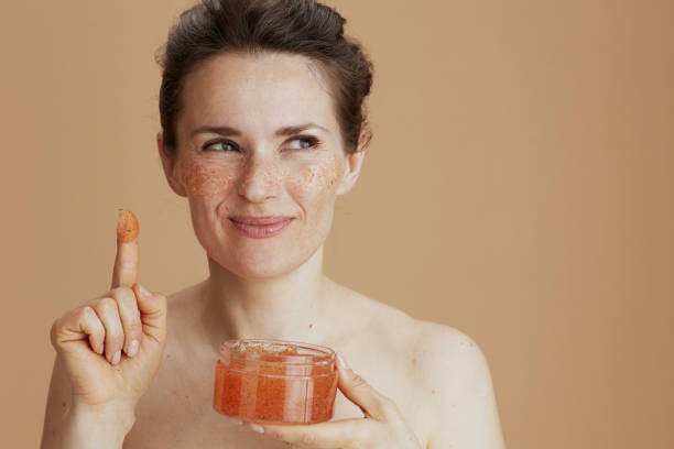 istock pensive modern 40 years old woman with face scrub 1635745388