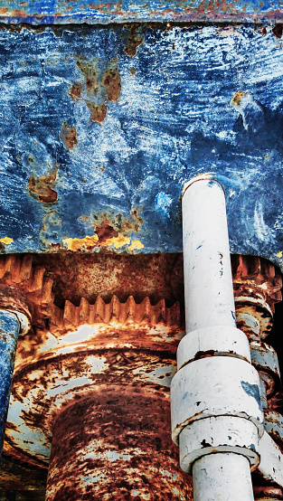 High resolution Image of an old scrapped rusty heavy duty manual marine winch gear wheel transmission mechanism detail.