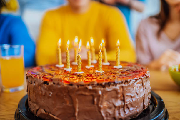 istock Birthday cake with lighted candles 1635759173