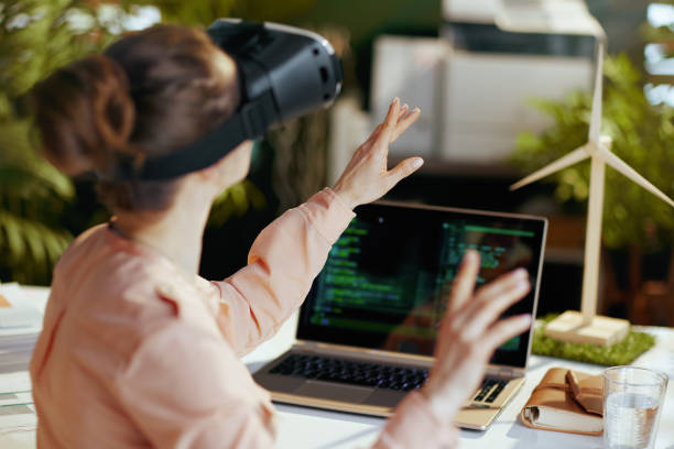 istock Seen from behind modern female with laptop and vr gear 1635794873