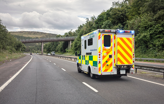 British ambulance responding to an emergency on a UK motorway