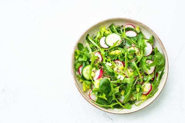 istock Green salad with spinach, arugula and radish with olive oil. 1635806240