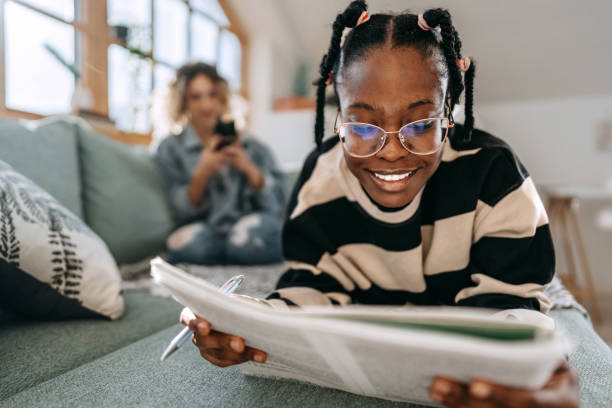 istock Female student reading book while laying on a bed at home 1635806247