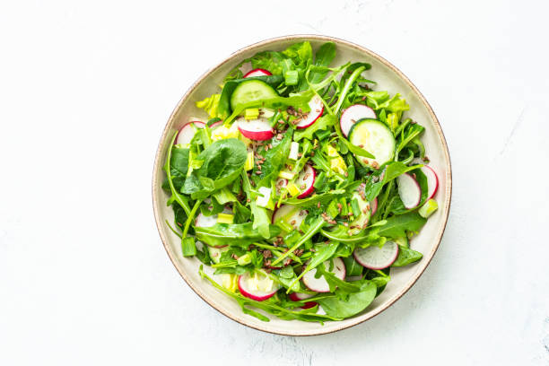 istock Green salad with spinach, arugula and radish with olive oil. 1635806597
