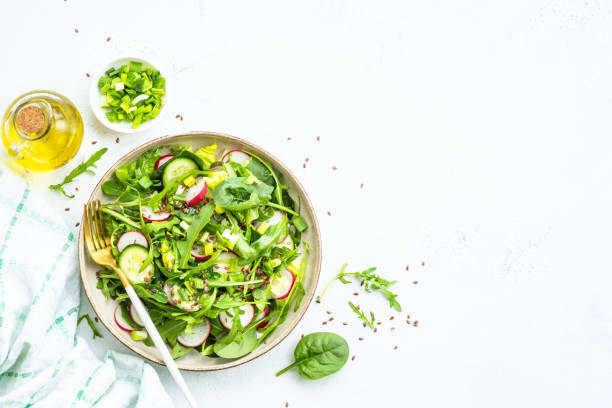 istock Green salad with spinach, arugula and radish with olive oil. 1635806769