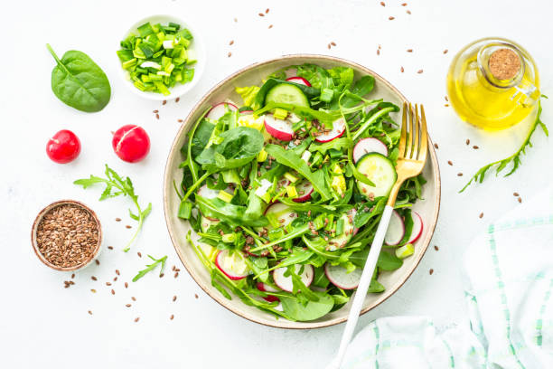 istock Green salad with spinach, arugula and radish with olive oil. 1635806770
