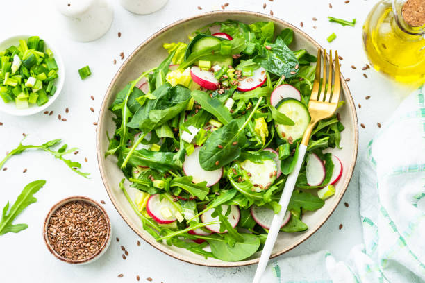 istock Green salad with spinach, arugula and radish with olive oil. 1635806796