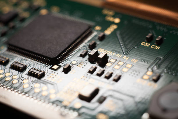 istock Macro photo of a green computer printed circuit board with selective focus on an blank chip 1635806818