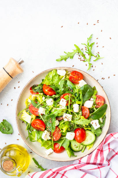 Green salad with spinach, arugula and radish with olive oil.