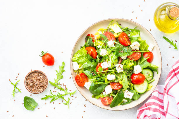 istock Green salad with spinach, arugula and radish with olive oil. 1635807317