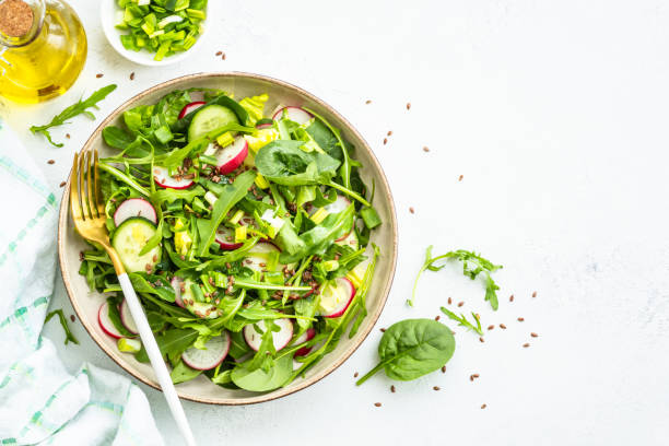istock Green salad with spinach, arugula and radish with olive oil. 1635807323