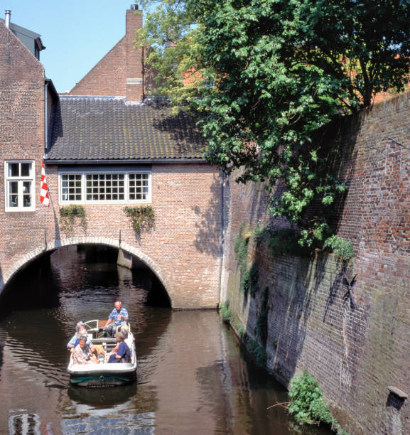DEN BOSCH, HOLLAND-JUNE 24,2018: A boat trip at the canal in 's-Hertogenbosch in the Netherlands that is called the Binnendieze and is full of beautiful brick arches