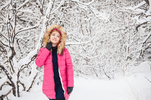 A young woman posing in Thingvellir National Park or better known as Iceland pingvellir National Park during winter